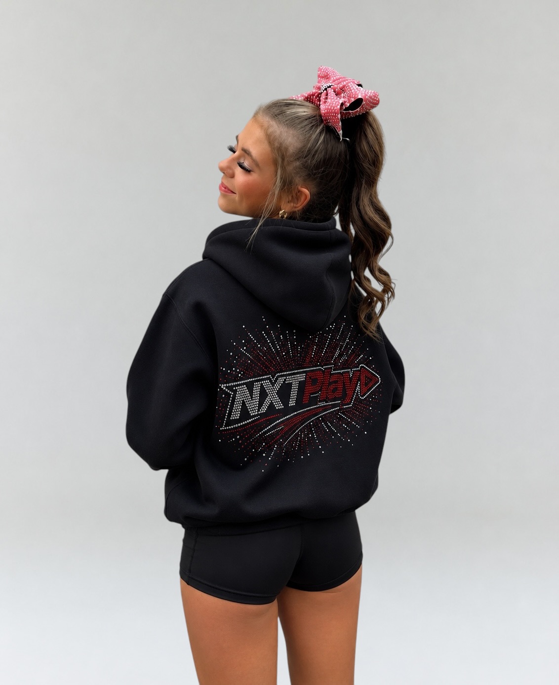 NXTPLAY rhinestone hoodie worn with black shorts